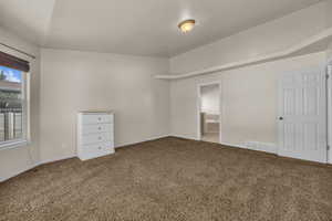 Carpeted empty room with baseboards