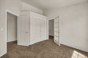 Unfurnished bedroom with carpet floors, french doors, and a closet