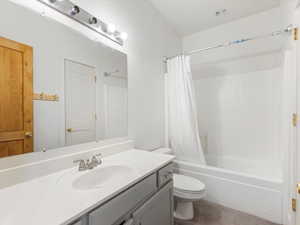 Full bath featuring vanity and shower / bathtub combination with curtain