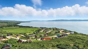 Aerial view of property and surrounding area with a water and mountain view and property boundaries highlighted
