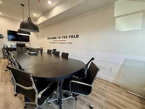 Office area featuring light wood finished floors and recessed lighting