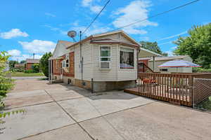 Back of house featuring a patio area, entry steps, and a wooden deck