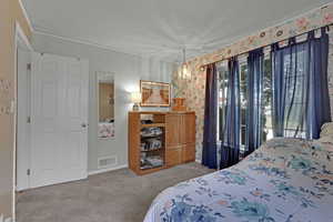 Bedroom featuring carpet and a chandelier