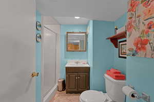 Bathroom featuring a shower stall and vanity
