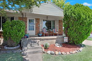 View of front facade with covered porch and brick siding