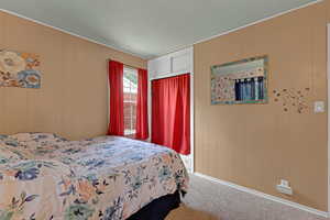 Bedroom featuring carpet flooring and ornamental molding