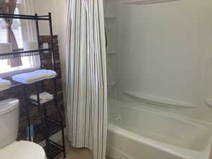 Bathroom featuring shower / bath combination with curtain