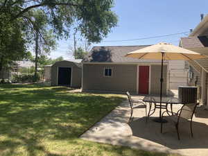 View of yard featuring a patio, a shed, and outdoor dining space