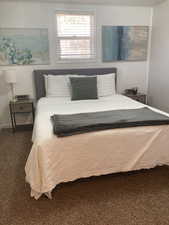 Carpeted bedroom featuring baseboards