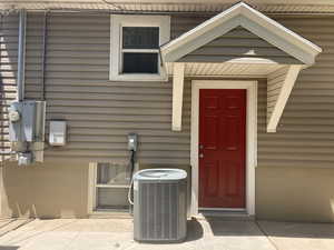 Doorway to property featuring central AC unit