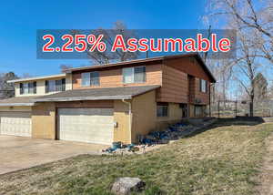 View of front of house with brick siding, concrete driveway, an attached garage, and roof with shingles