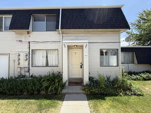 View of front of property featuring roof with shingles and mansard roof