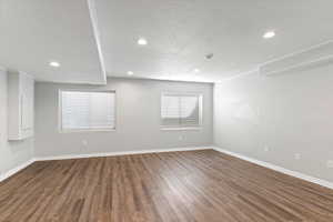 Unfurnished room with wood finished floors, recessed lighting, a textured ceiling, and a smoke detector
