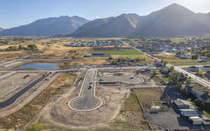 Aerial view of property and surrounding area with a mountain backdrop