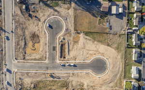 Aerial view of property and surrounding area featuring nearby suburban area