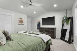 Bedroom featuring lofted ceiling, light colored carpet, a ceiling fan, and recessed lighting