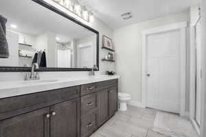 Bathroom featuring double vanity and a shower
