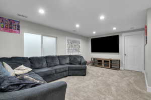 Carpeted living area featuring recessed lighting