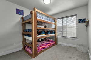 Bedroom with carpet and a textured ceiling