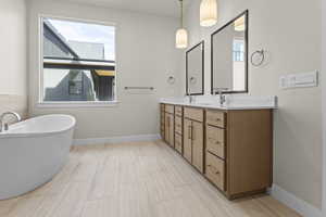 Full bath with a freestanding tub and double vanity