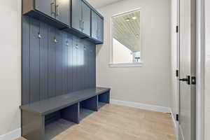 Mudroom with baseboards and light wood-style flooring