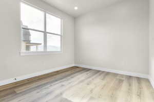 Spare room featuring wood finished floors and recessed lighting