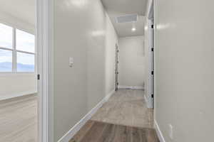 Corridor with wood finished floors and baseboards