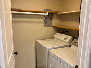Laundry room featuring washing machine and clothes dryer and electric panel