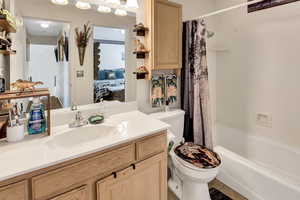 Ensuite bathroom featuring vanity and shower / bath combo