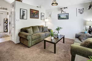 Tiled living area with carpet and baseboards