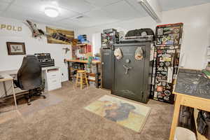 Office space with carpet and a paneled ceiling
