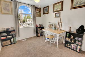 Office area featuring carpet flooring and a ceiling fan