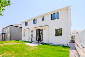 Rear view of house featuring stucco siding