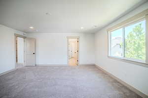 Unfurnished room with light carpet and recessed lighting