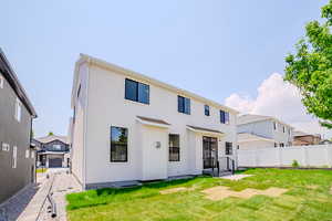 Back of house featuring stucco siding