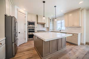 Kitchen with appliances with stainless steel finishes, decorative backsplash, light countertops, and recessed lighting