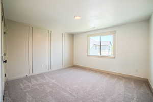 Spare room featuring light carpet