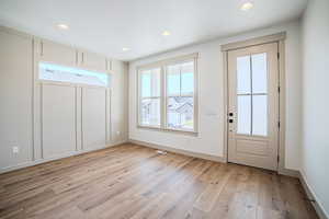 Entrance foyer featuring light wood-type flooring and recessed lighting