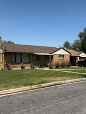 Single story home with a front lawn and an attached garage