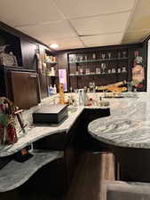 Bar area featuring a drop ceiling