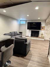 Living room featuring a fireplace, wood finished floors, and recessed lighting