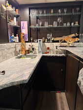 Bar featuring a sink and decorative backsplash