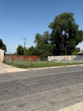 View of asphalt road featuring curbs