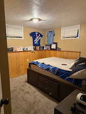 Carpeted bedroom with a textured ceiling