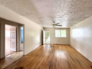 Unfurnished room featuring ceiling fan and hardwood / wood-style flooring