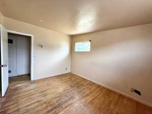 Spare room with baseboards and wood finished floors