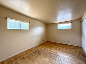 Empty room featuring light wood finished floors and baseboards