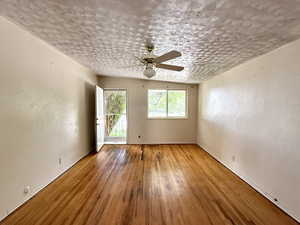Unfurnished room featuring a ceiling fan and hardwood / wood-style flooring