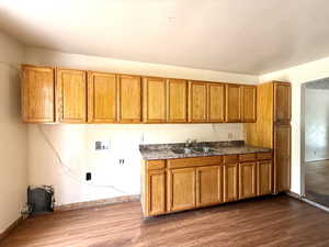 Kitchen with brown cabinets and dark wood finished floors