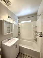 Bathroom with  shower combination, vanity, and tile patterned floors